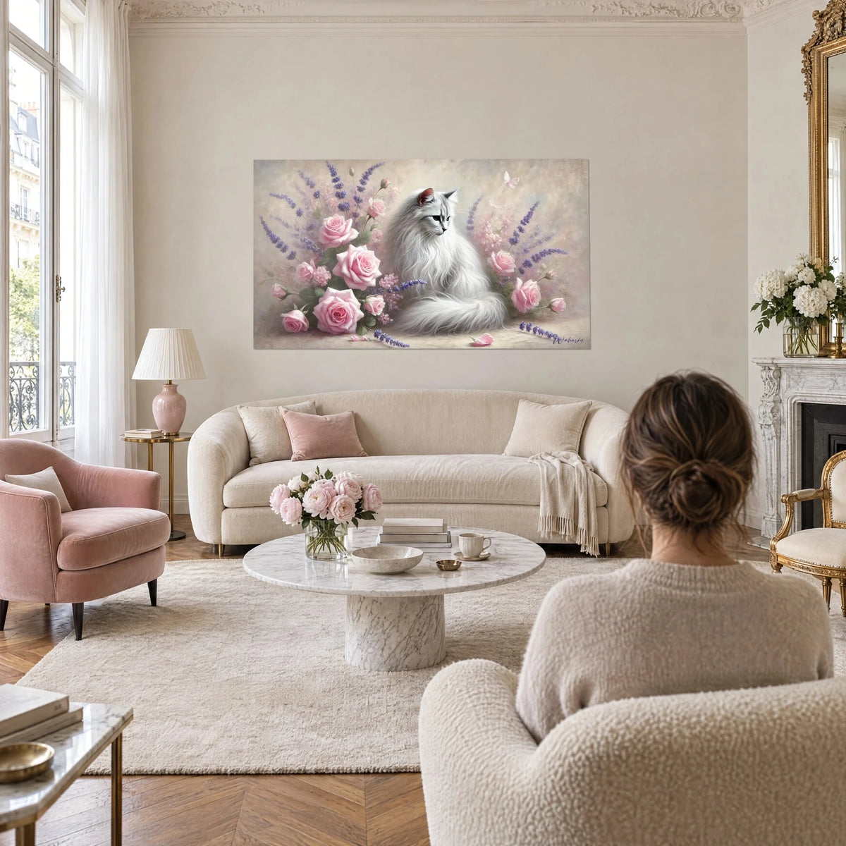 Wall art of a silver Persian cat surrounded by pale pink roses and purple lavender, hung above a sofa in a bright living room