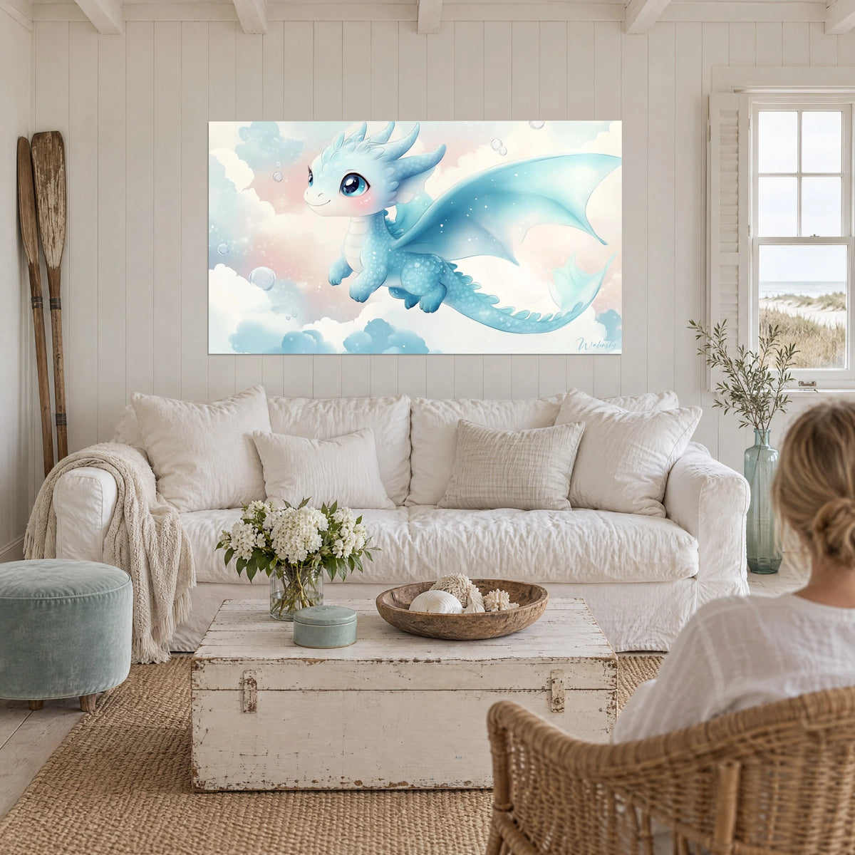 Wall art of a baby blue dragon with wings spread wide in icy blue, pale pink clouds and bubbles, above a sofa in a bright living room