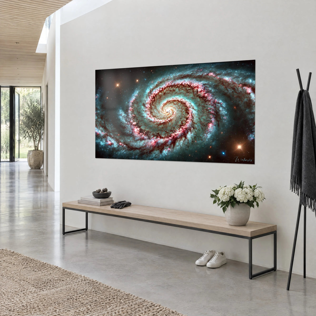Wall art swirling nebula with a cream core, burgundy and cyan arms on a starry black background, white wall, wooden bench