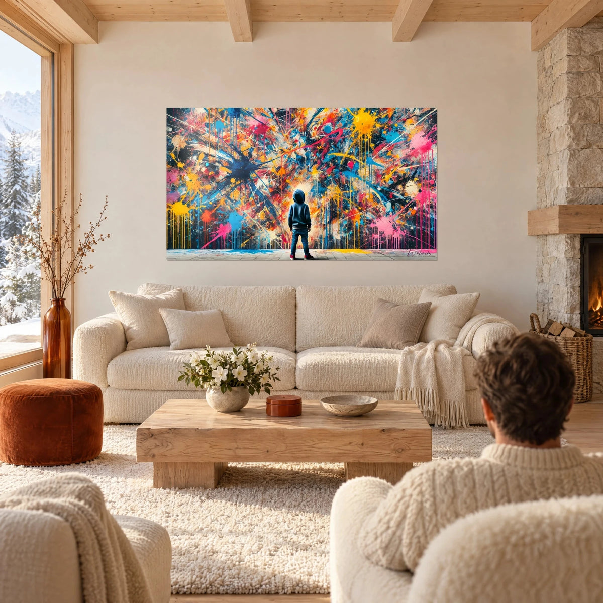 Wall art child in a hooded sweatshirt facing a wall of yellow and pink paint splatters, above a sofa in a bright living room
