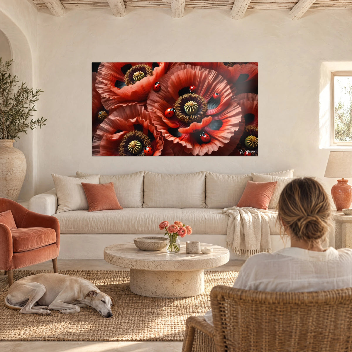 Wall art of crumpled scarlet poppies with black-spotted ladybugs and green stamens, above a sofa in a bright living room