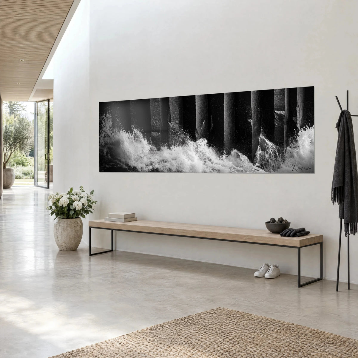 Wall art dark basalt columns battered by a white sea, spray and deep black, three-quarter view on a light wall