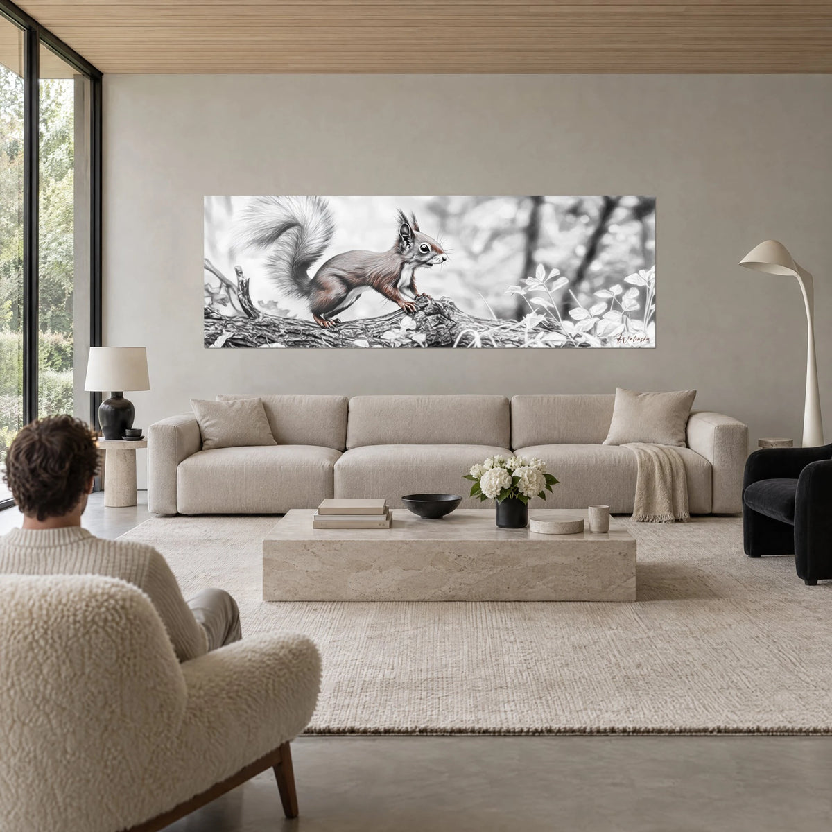 Wall art red squirrel with brush-tipped ears and a grey plume of a tail on its trunk, above a sofa in a bright living room