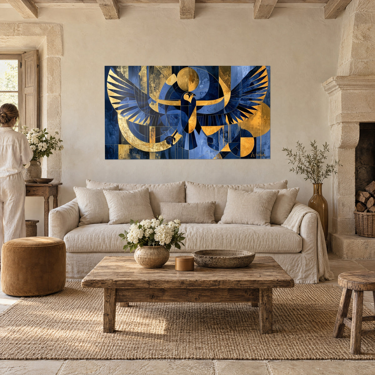 Wall art Horus falcon with outspread wings in midnight blue and gold, golden sun disc, above a sofa in a bright living room