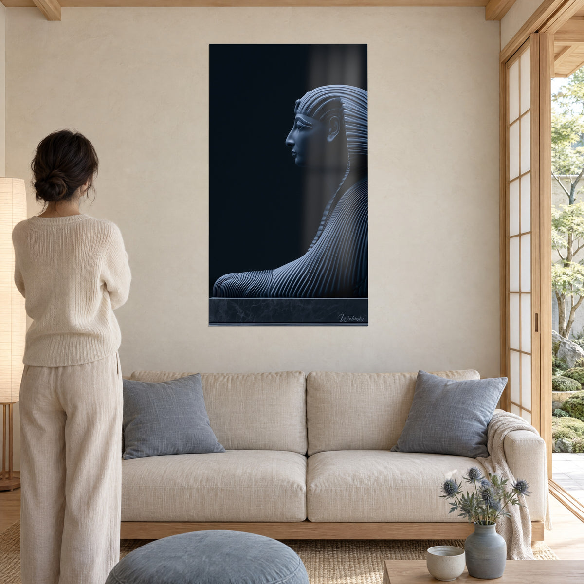 Wall art sphinx in profile in midnight blue and charcoal, pleated nemes headdress, above a sofa in a bright living room