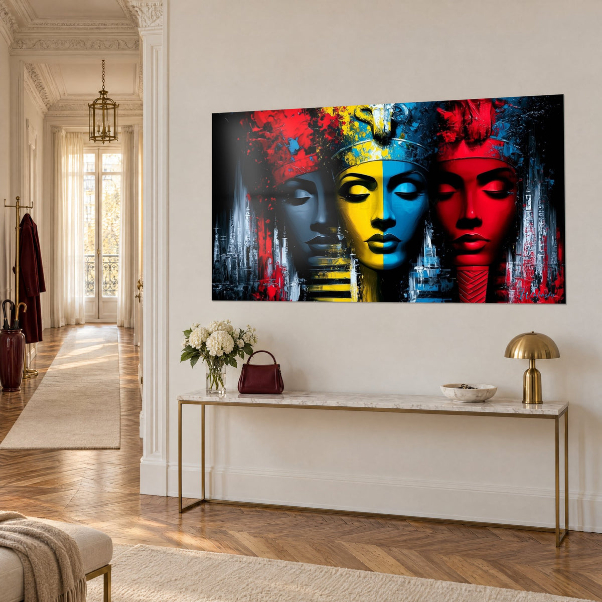 Wall art of Egyptian guardians with closed eyes, bright red, black and yellow mask, on a gilded console in a Haussmann-style hallway