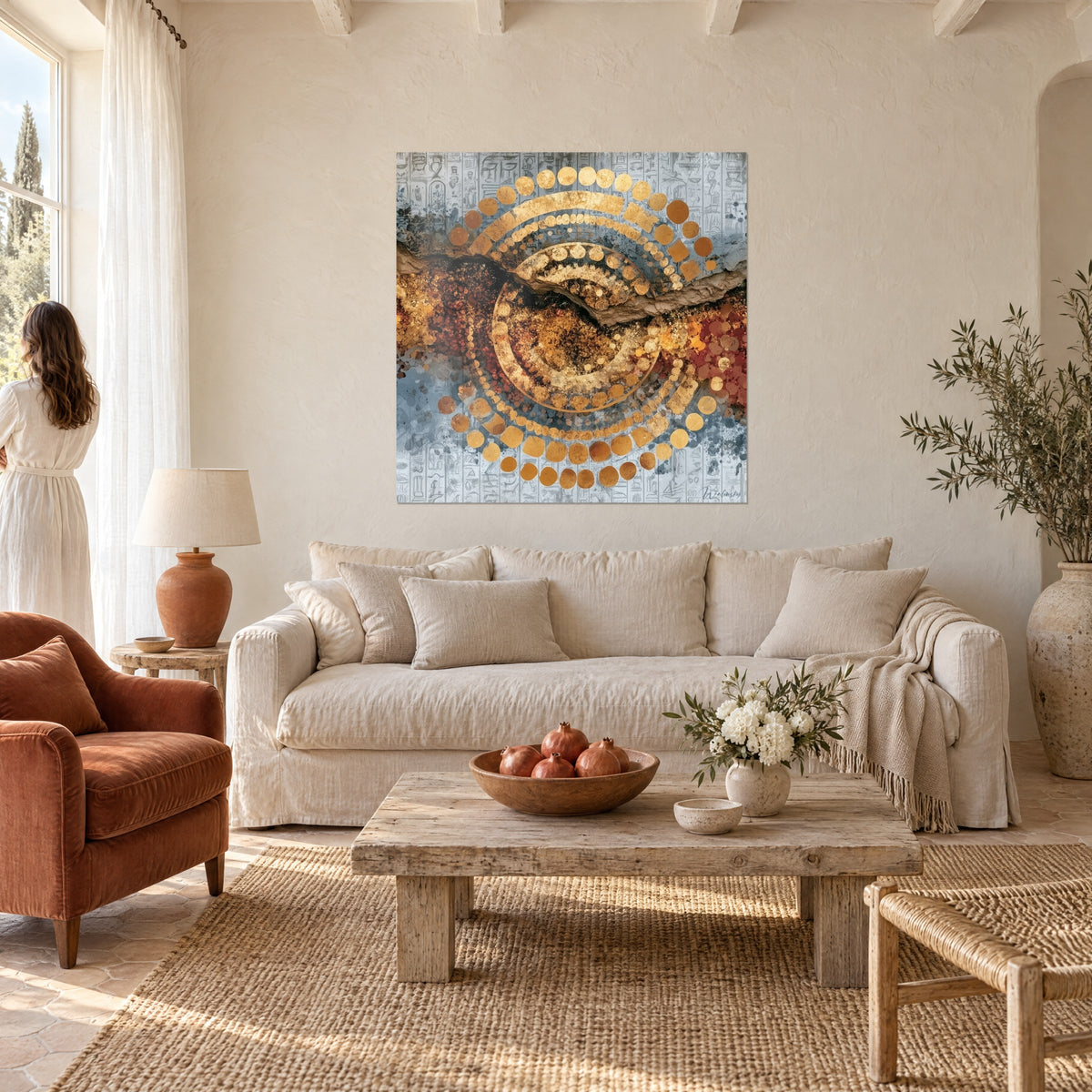 Wall art with a dotted golden circle on grey and blue hieroglyph background, ochre crack, above a sofa in a bright living room