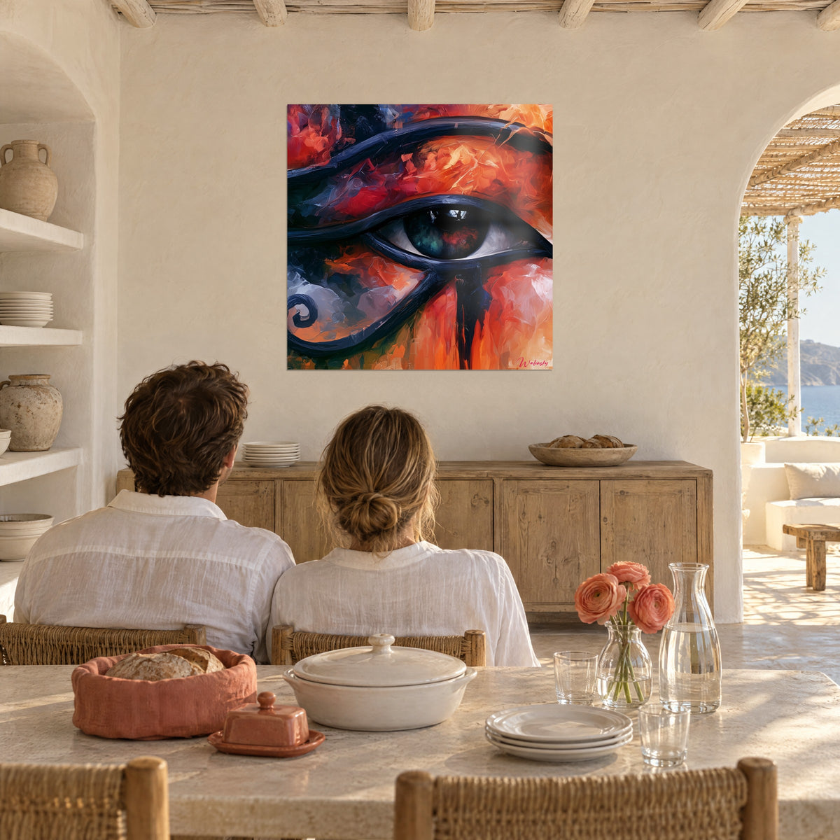 Quadro simbolo di Horus in pittura a olio rossa e blu notte, iride verde, di fronte a una coppia, sala da pranzo bianca