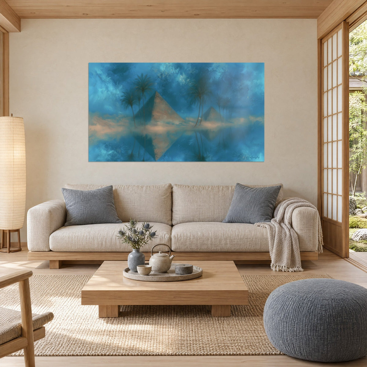Wall art golden pyramids bathed in midnight-blue mist and dark palm trees, reflections on the water, above a sofa in a bright living room