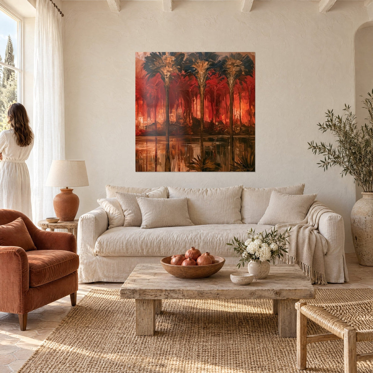 Wall art trio of dark palm trees on glowing ember-red background, copper reflections on the water, above a sofa in a bright living room