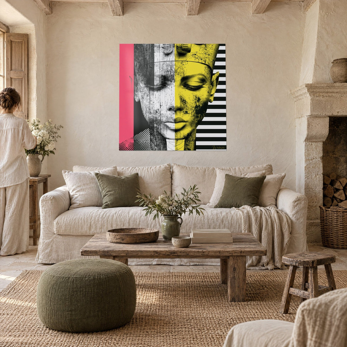 Wall art Egyptian queen with closed eyes, half cracked grey and half lemon yellow, pink background, above a sofa in a bright living room