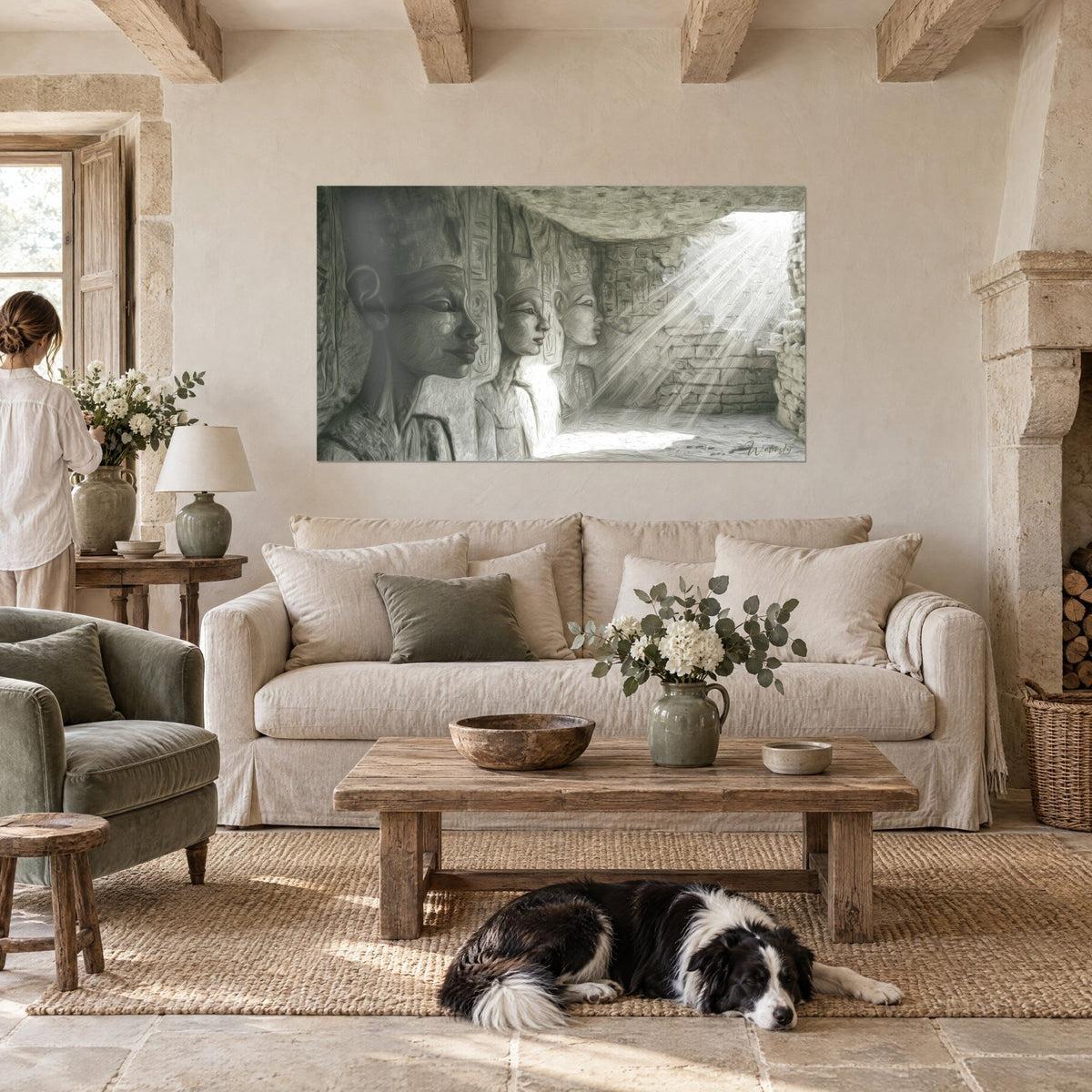 Wall art with three sculpted pharaoh profiles in pearl grey and white, rays of light in a temple, above a sofa in a bright living room