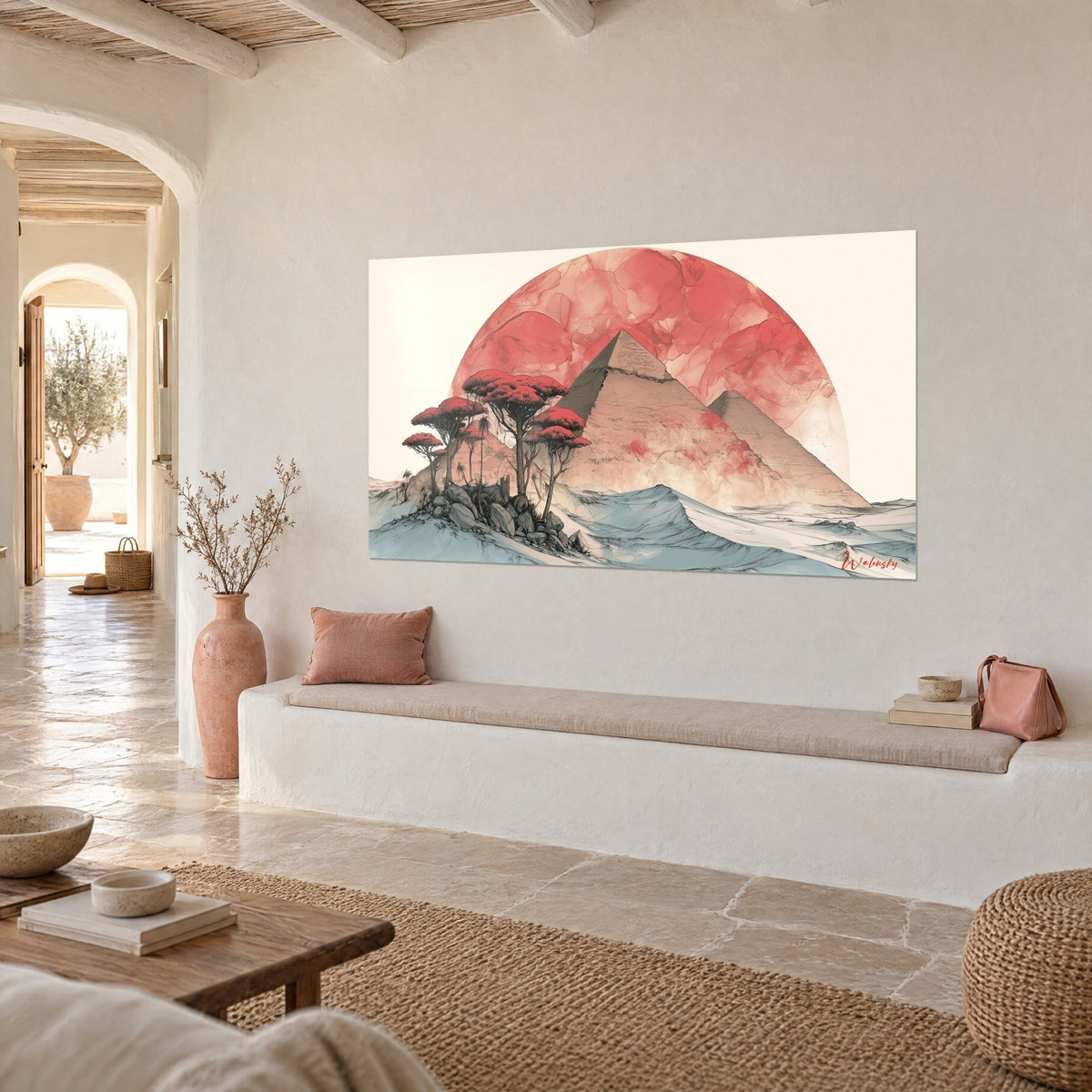 Watercolor wall art of Egypt, blue-grey dunes and a coral disc behind two pyramids, hung in a light vaulted alcove