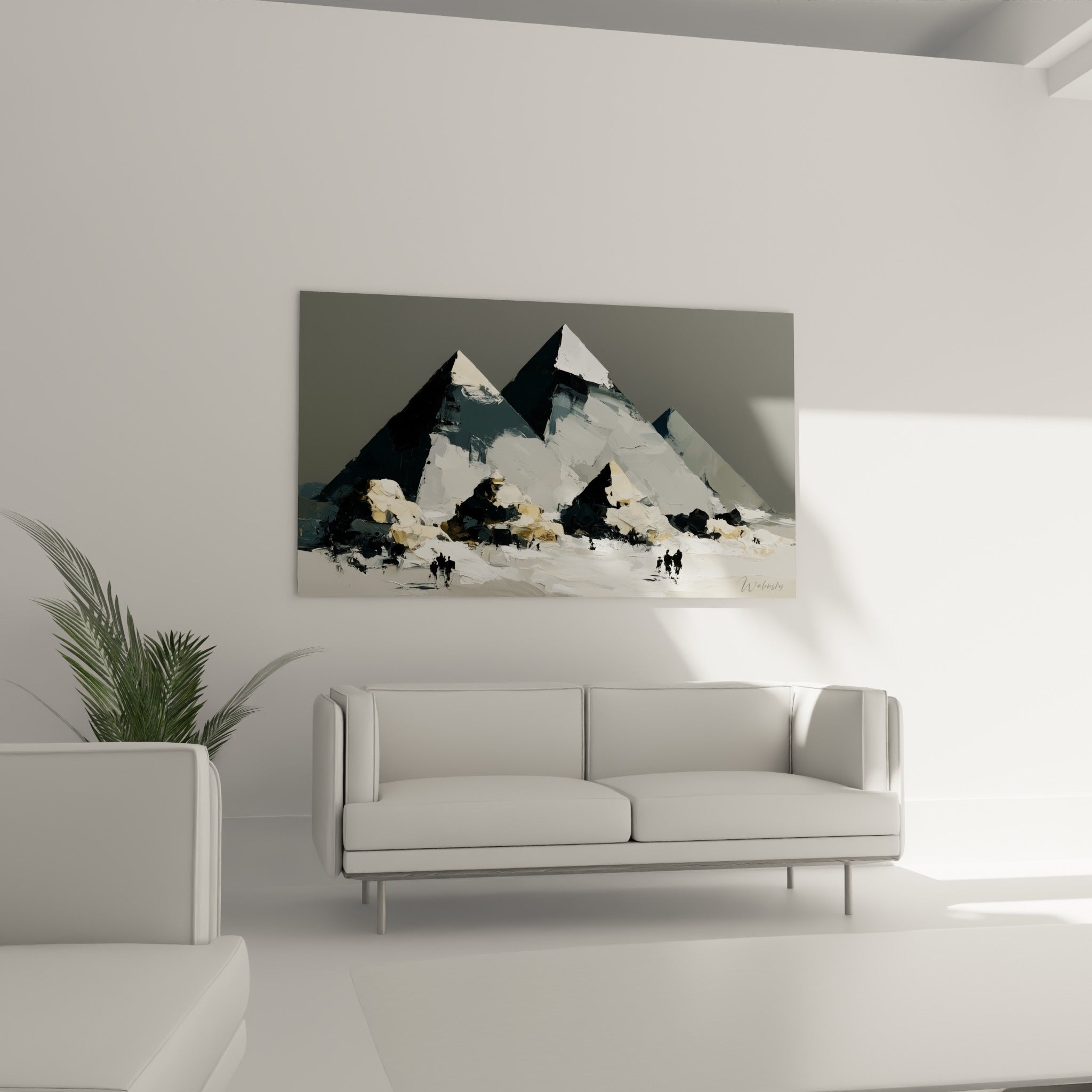 Monuments égyptiens en camaïeu de gris et blanc accrochés au-dessus d'un canapé dans un salon lumineux