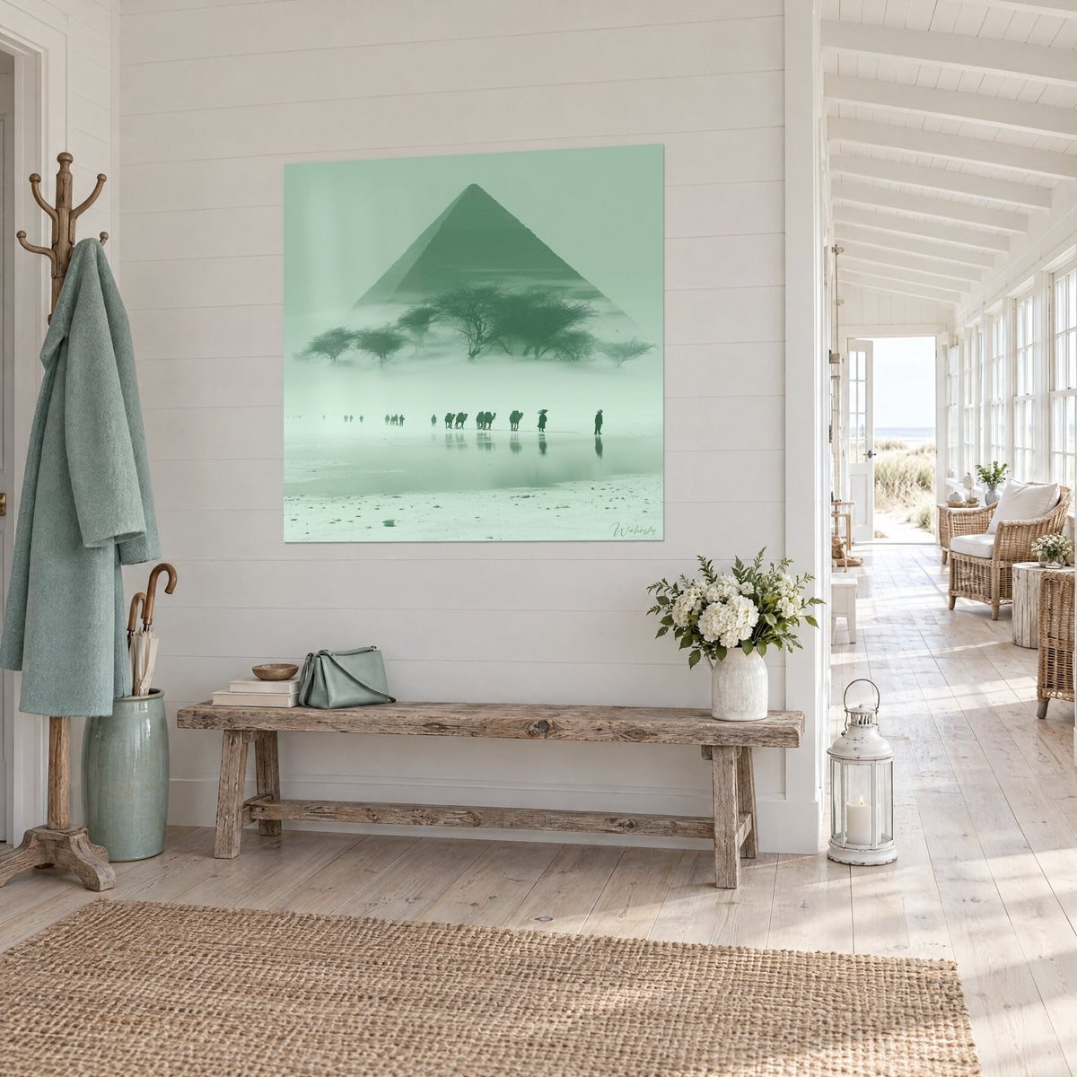 Wall art large mint green pyramid, sprawling acacias and camel silhouettes on a white floor, three-quarter view, bright hallway