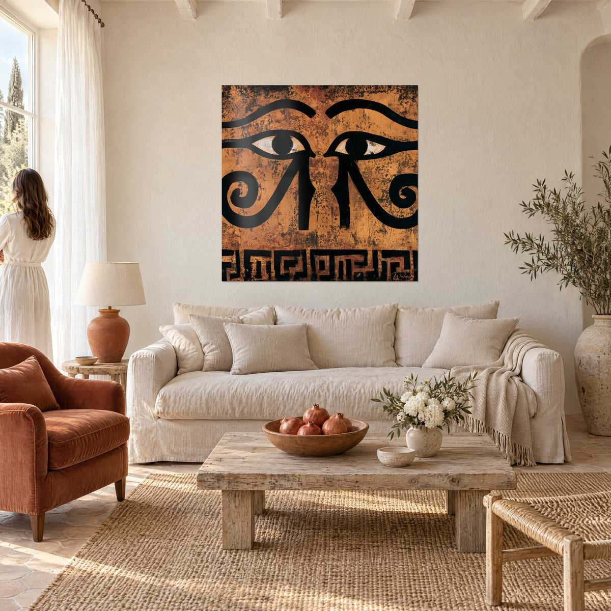 Wall art twin Eye of Horus in ochre and black, spirals on a copper background, a woman seen from behind above a sofa in a bright living room
