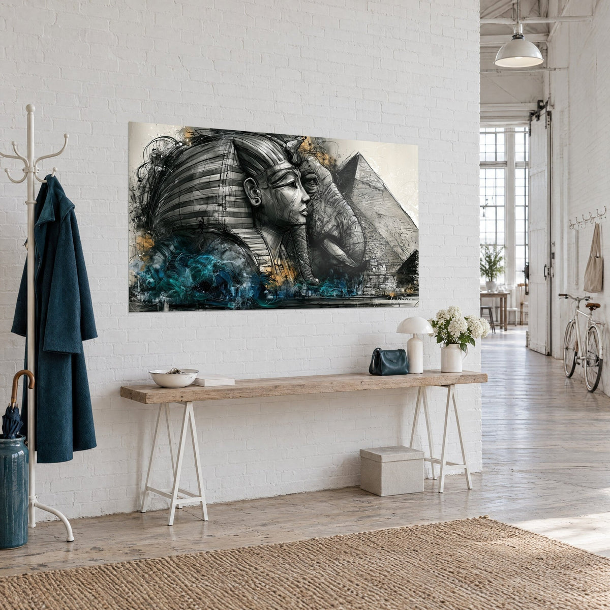 Wall art striped pharaoh mask and elephant trunk, grey stone pyramid, navy blue waves and ochre touches, three-quarter view on a white wall
