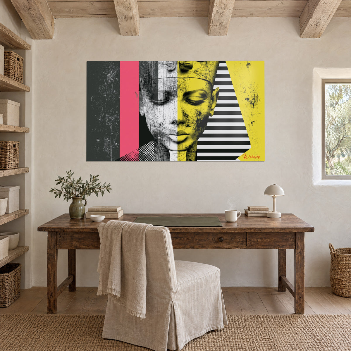 Cuadro efigie egipcia con mirada baja, amarillo mostaza, gris carbón y rosa, encima de un escritorio de madera en una habitación abovedada