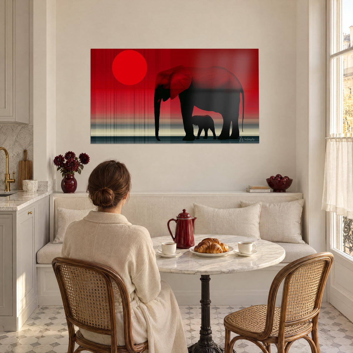 Wall art elephant calf nestled under its black mother, vivid red sun, beige and slate stripes, cream banquette and woman seen from behind, breakfast