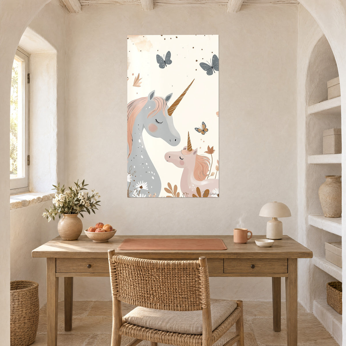 Cuadro ilustración infantil de dos unicornios pastel, mariposas gris azulado sobre fondo crema, en la pared de un escritorio de madera junto a un nicho