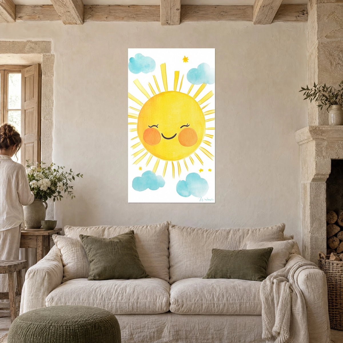 Wall art of a laughing yellow sun with rosy orange cheeks, surrounded by sky-blue clouds, above a sofa in a bright living room