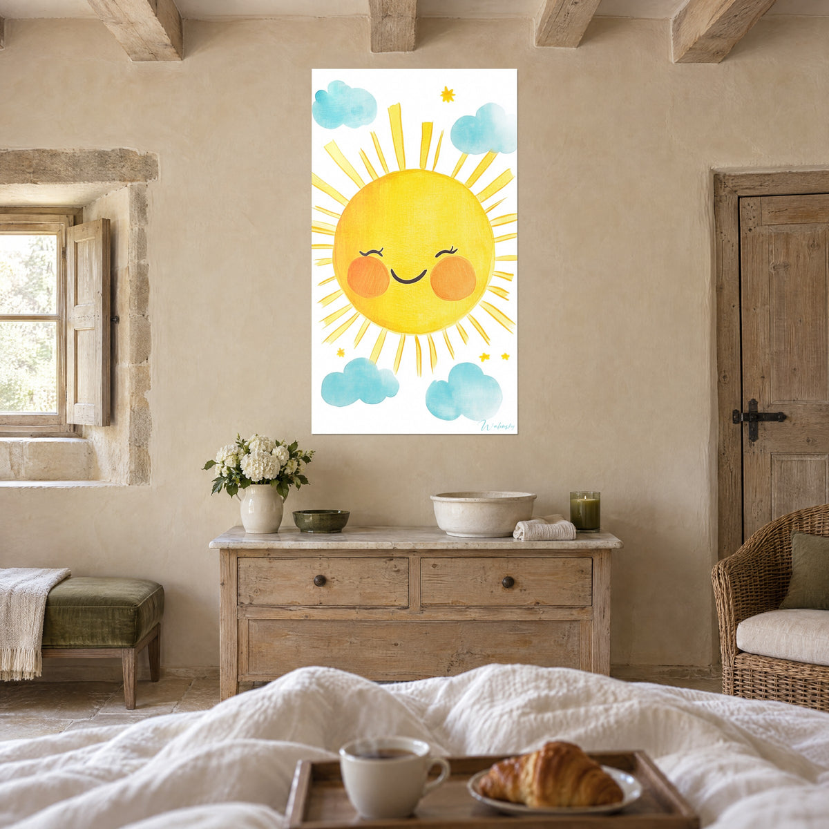Wall art of a chubby-cheeked sun with closed eyelids, bright yellow and soft orange, above a bed in a light bedroom
