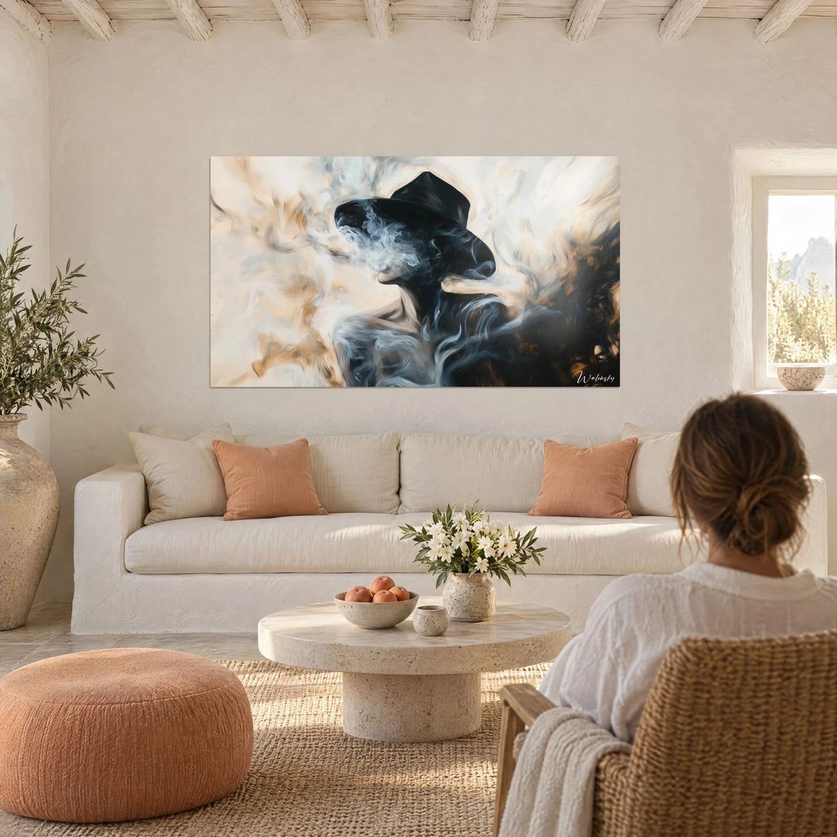 Wall art black felt-marker silhouette drowned in white smoke, ochre and cream, a woman seen from behind above a sofa in a bright living room