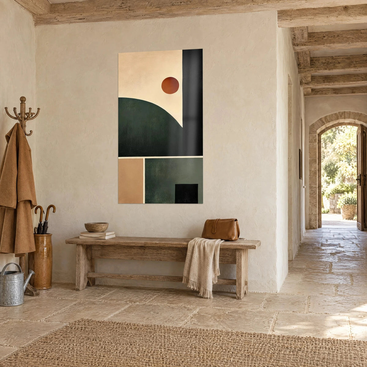 Wall art with a rounded forest-green shape under a terracotta disc, beige and black planes, in the hallway of a stone house