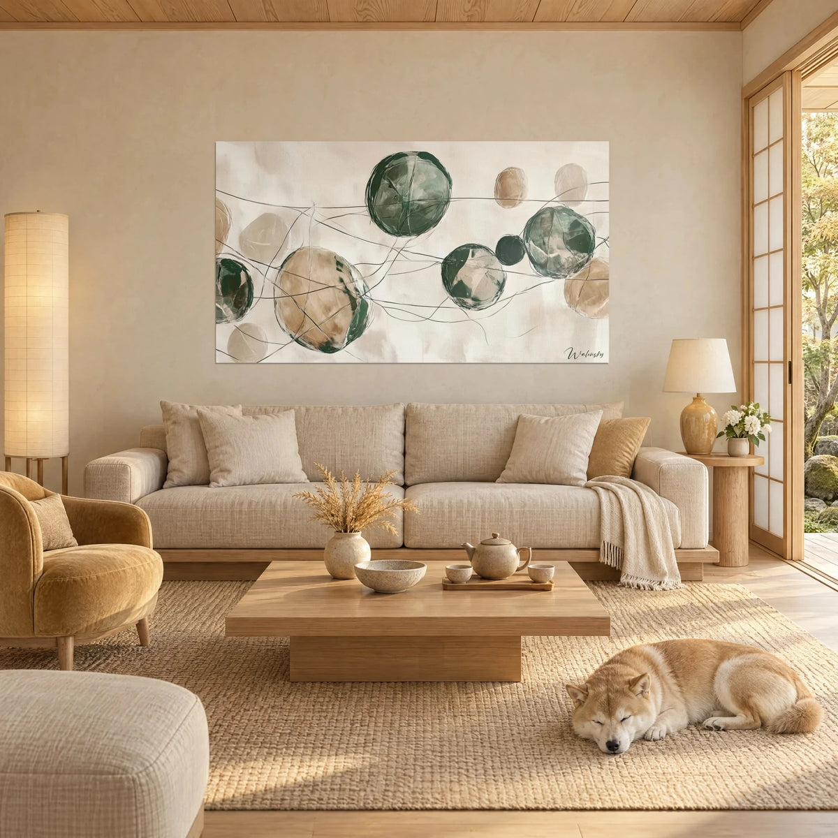 Tableau sphères vert sapin et beige sable reliées par des fils noirs, Shiba endormi, au-dessus d'un canapé dans un salon lumineux