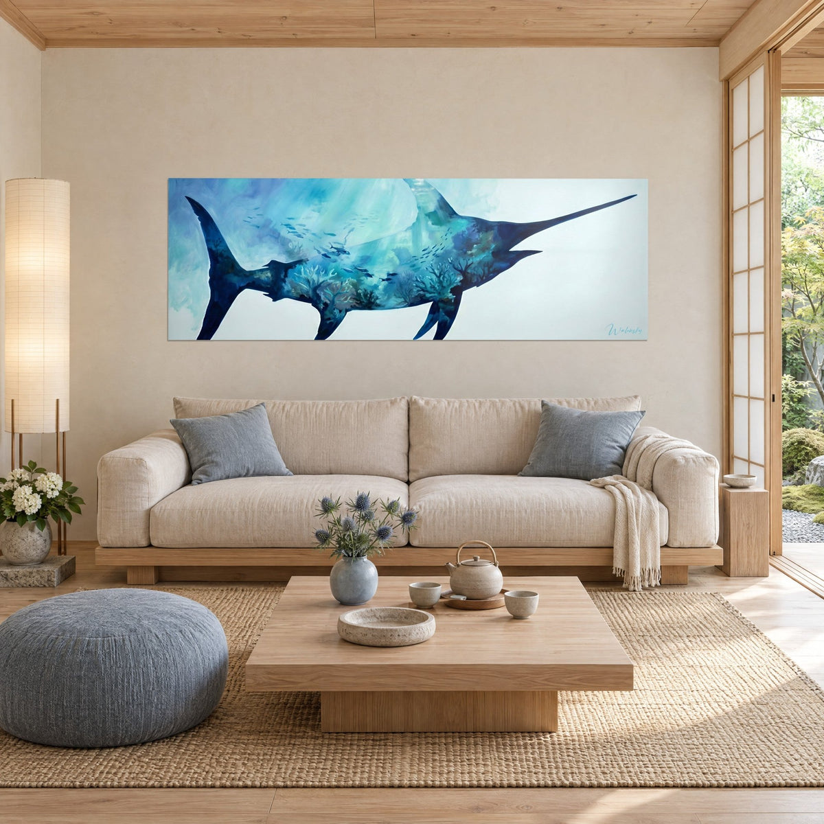 Wall art navy blue swordfish with turquoise coral branches, bill pointing right, above a sofa in a bright living room