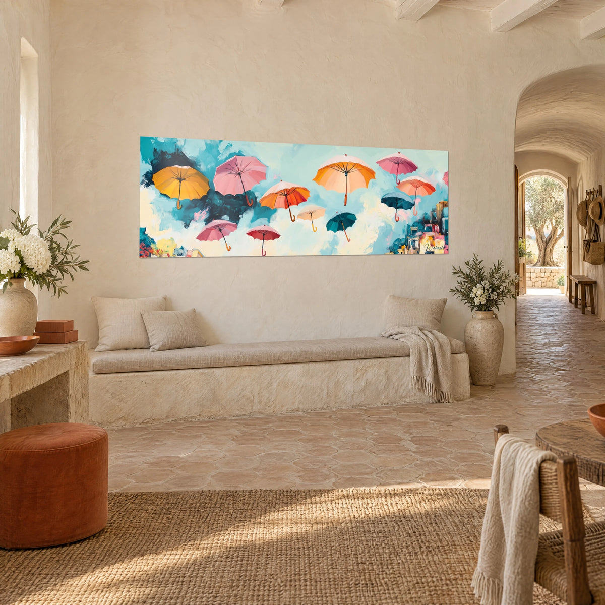Wall art of suspended saffron yellow and teal umbrellas in a cloudy sky, three-quarter view, bench of a Provençal farmhouse