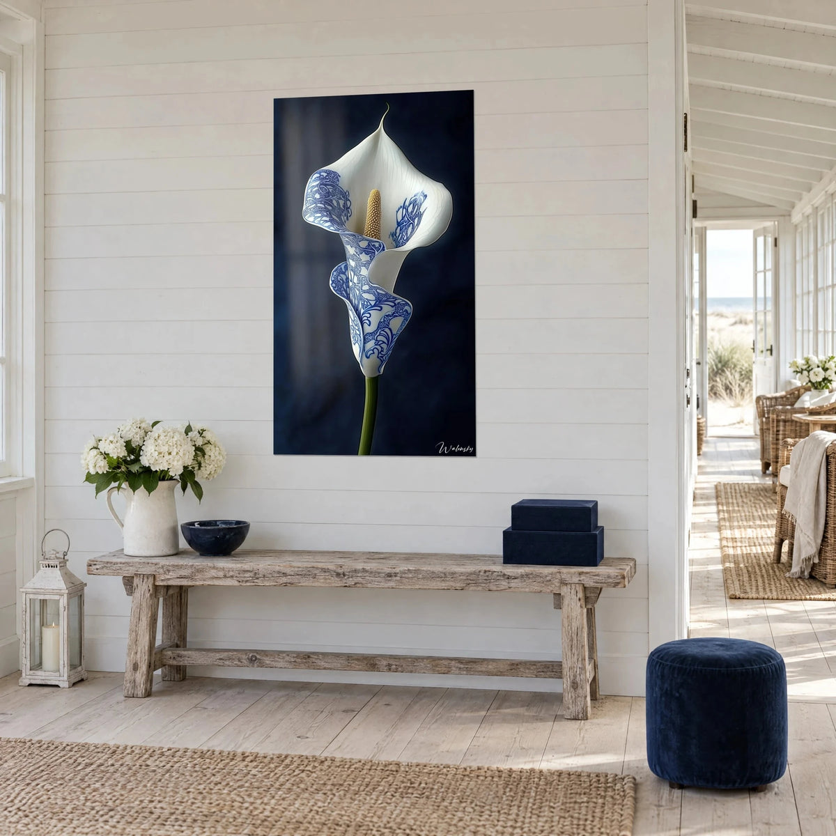Wall art calla in ivory and indigo porcelain, golden spadix, three-quarter view above a light wood console