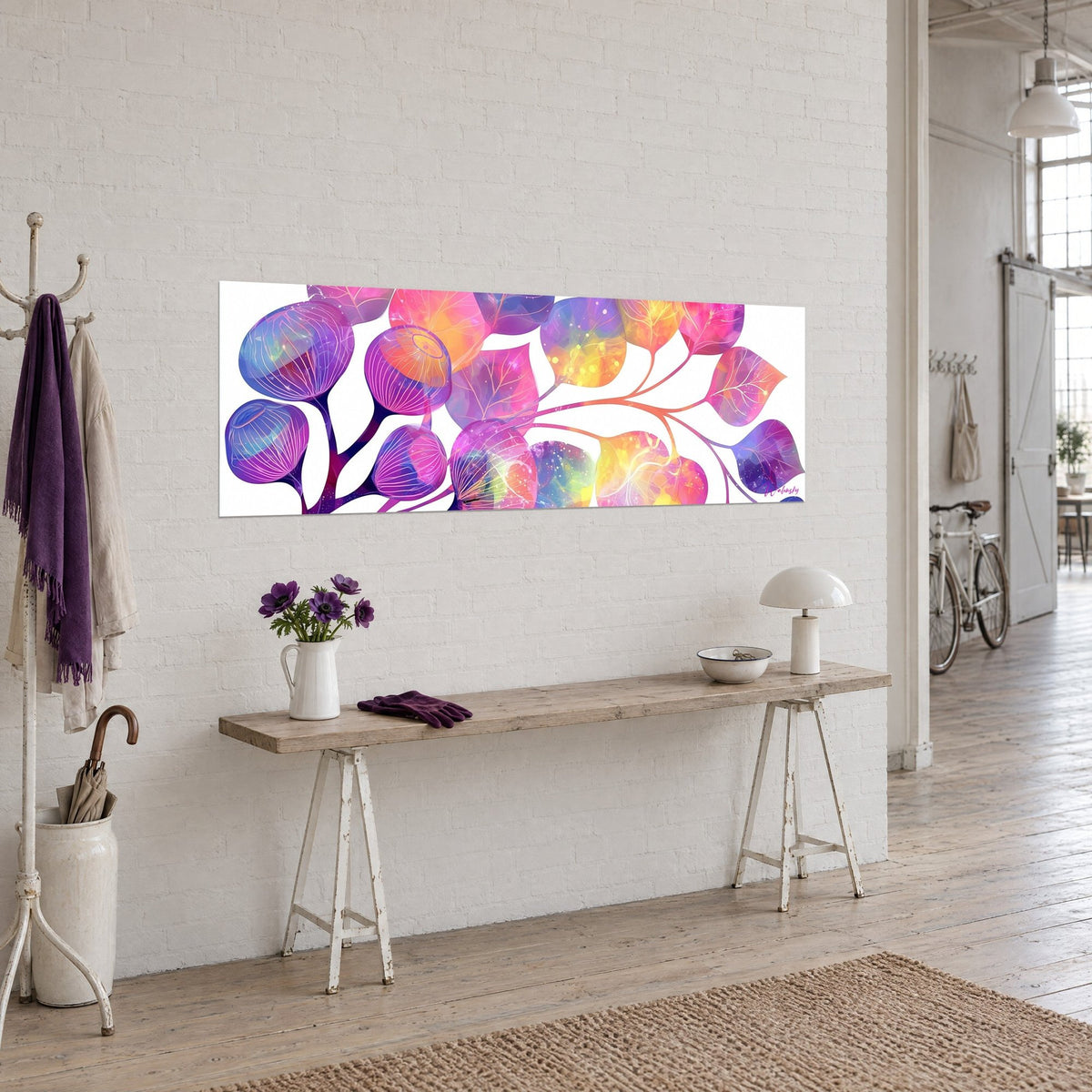Cuadro rama en flor con hojas ovaladas en rosa fucsia y amarillo sol, colgado en una pared de ladrillos blancos