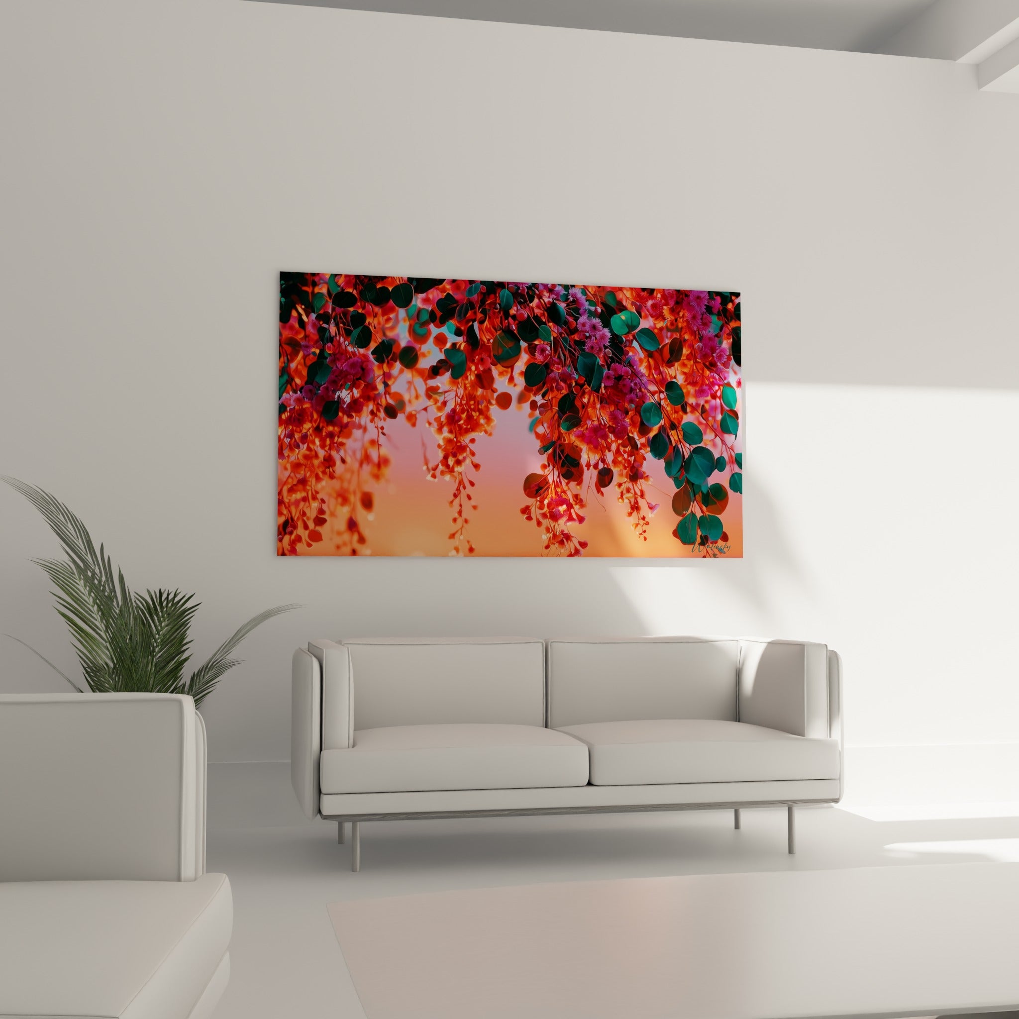 Branches d'eucalyptus fleuries roses et vertes accrochées au-dessus d'un canapé dans un salon lumineux