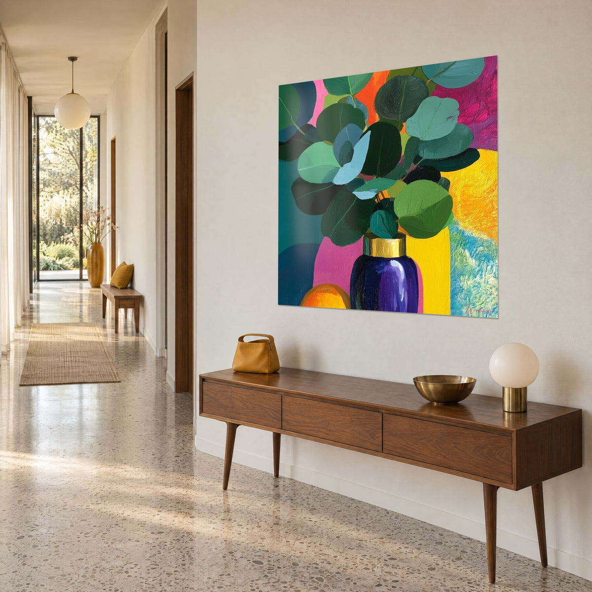 Schilderij bladerboeket in mintgroen in een indigoblauwe fles met gouden rand, oranje en felroze achtergrond, opgehangen boven een houten console