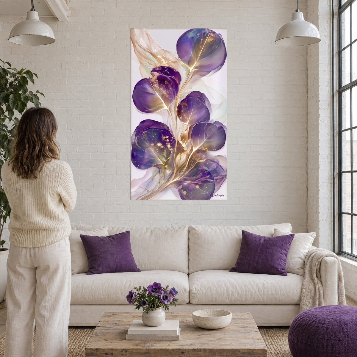 Schilderij paarse eucalyptusbladeren met gouden nerven op witte achtergrond, boven een bank in een lichte woonkamer