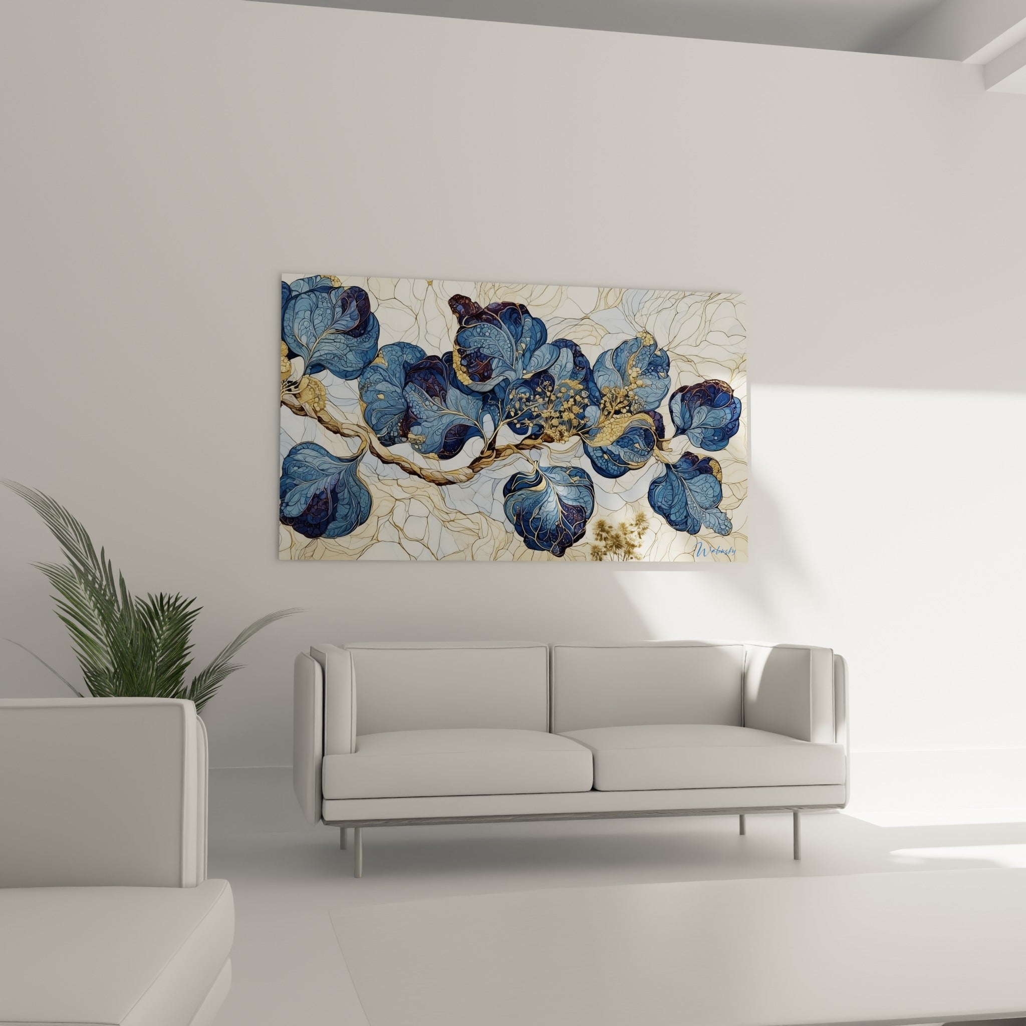 Branche eucalyptus bleu marine et beige sable placée au-dessus d'un canapé dans un salon lumineux.