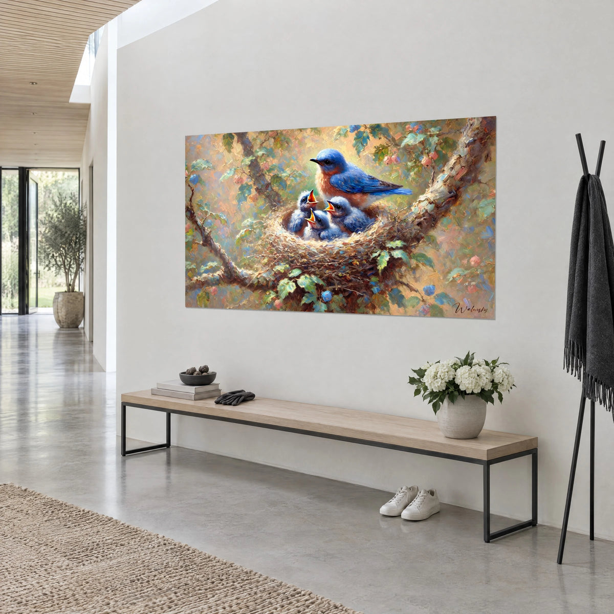 Wall art twig nest sheltering blue-grey chicks with orange beaks, leafy branch in green and pink, white wall and wooden bench
