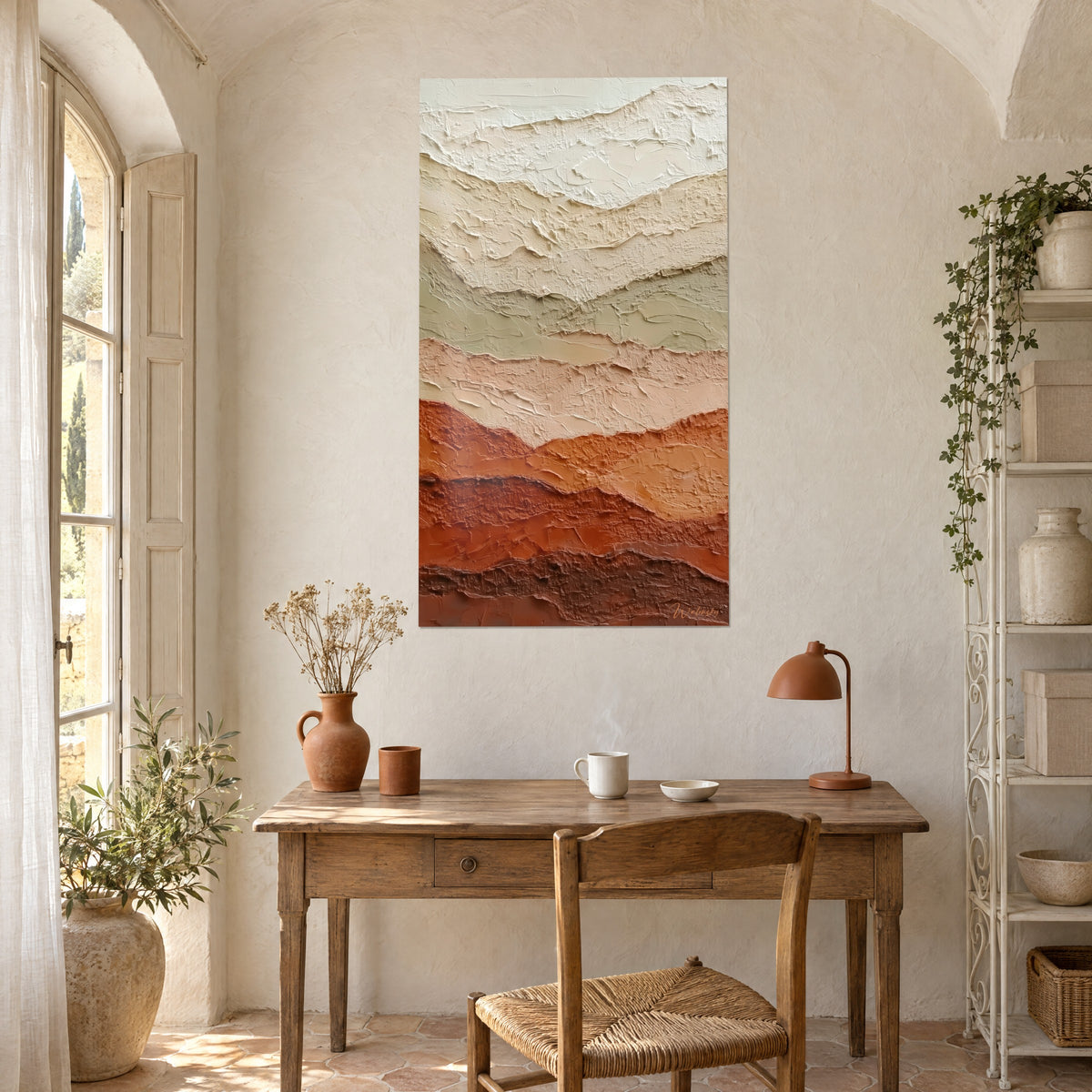 Wall art with textured earth bands in almond green and copper orange, hung above a light wood desk
