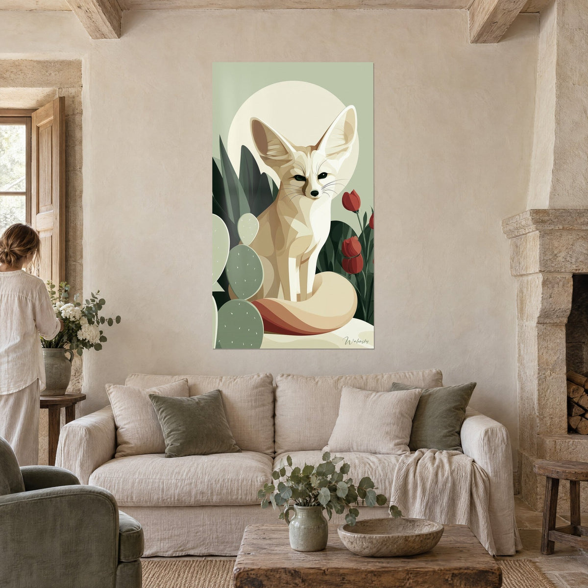 Wall art desert fox with large cream ears against a pale moon, green cacti and red tulips, above a sofa in a bright living room