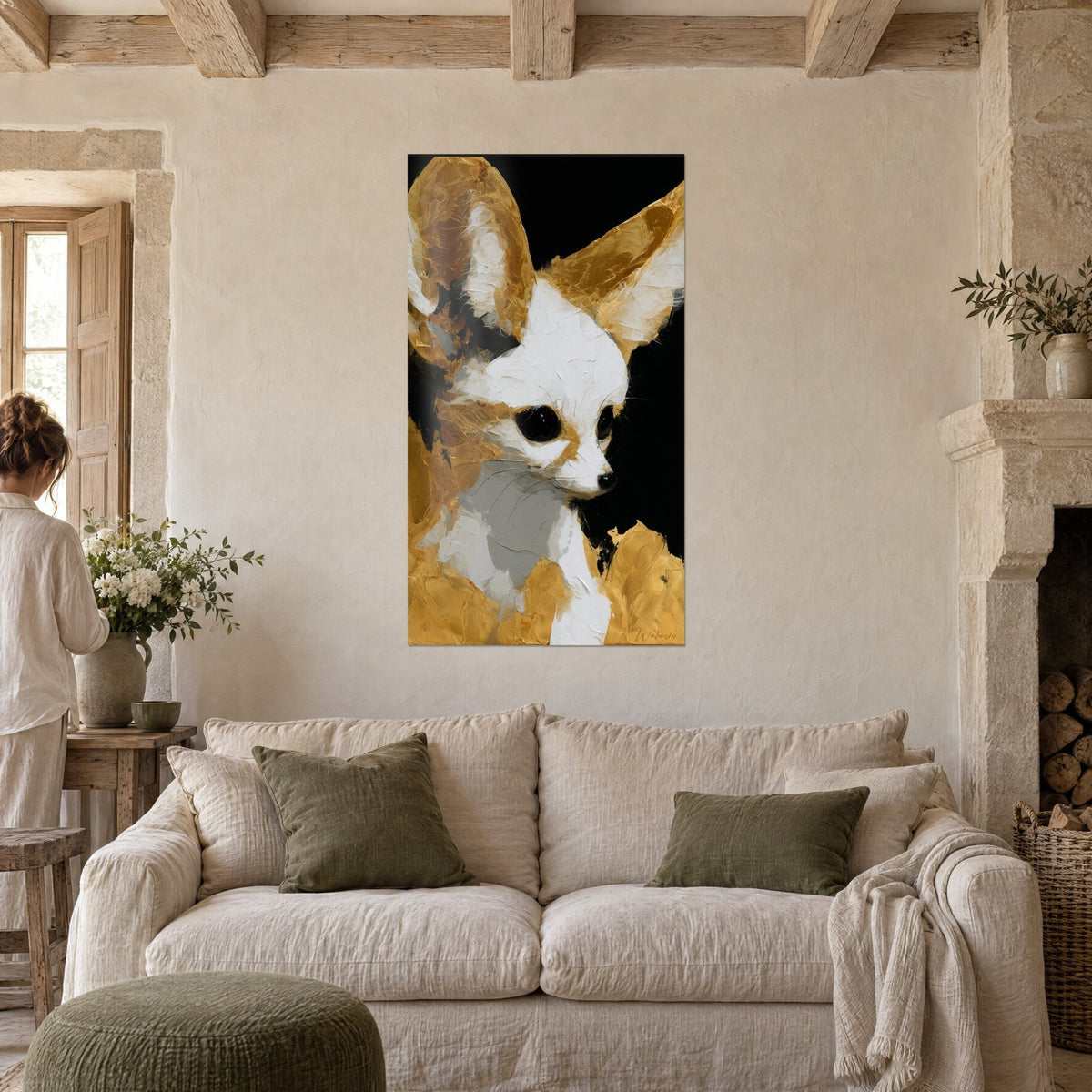 Wall art of a young desert fox with large golden ears, white fur on a black background, above a sofa in a bright living room