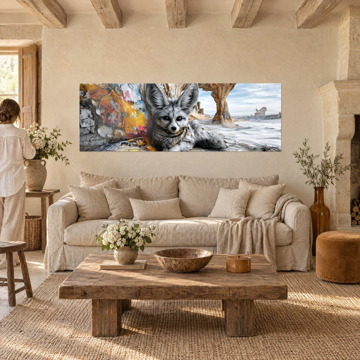Wall art grey fennec fox with large ears lying beside saffron yellow and pink paint drips, hanging above a sofa in a bright living room