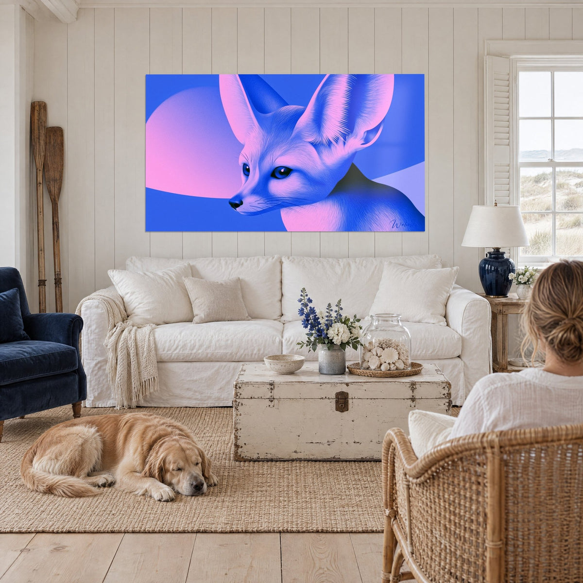 Wall art fennec fox with large pink ears, violet crescent moon and blue background, above a sofa in a bright living room