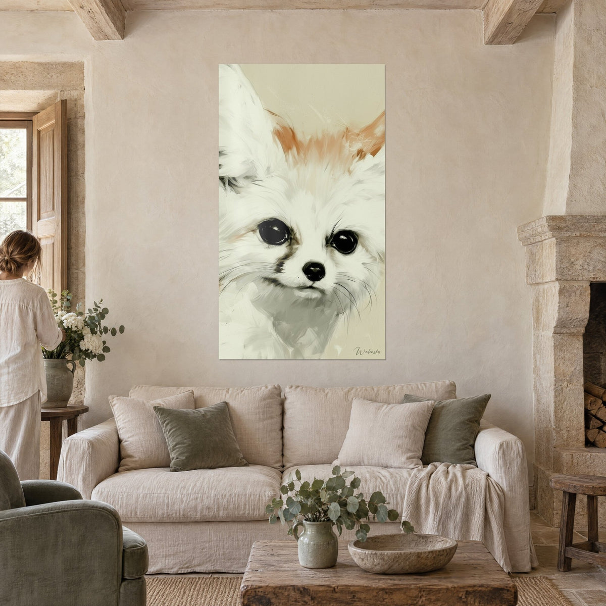 Wall art small desert fox with large white and orange ears, black muzzle, hung above a sofa in a bright living room