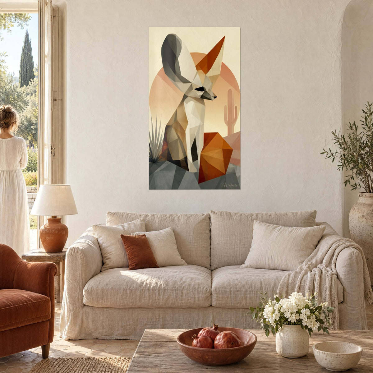 Wall art of a sand fox with large ears in beige and rust-colored facets, orange disc and cactus, above a sofa in a bright living room