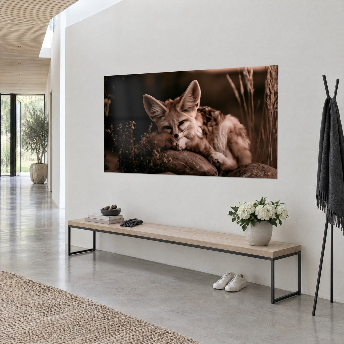 Wall art curled-up desert fox, muzzle resting on its paw, sepia and russet tones, three-quarter view in a hallway with white walls