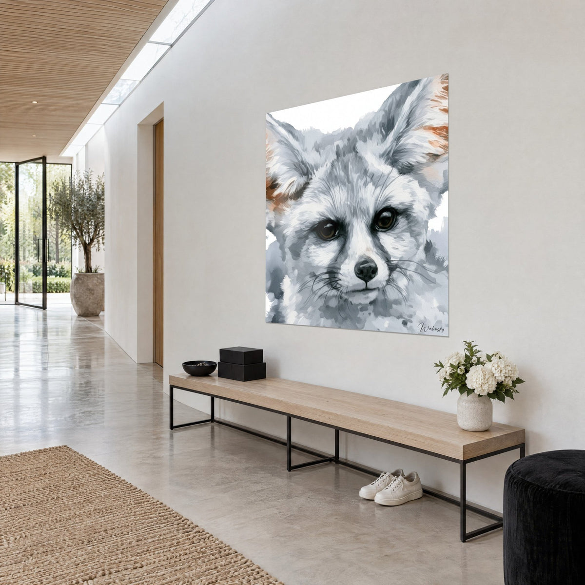Wall art fennec fox with white fur flecked with grey, black muzzle and copper-toned ears, light wall and wooden bench