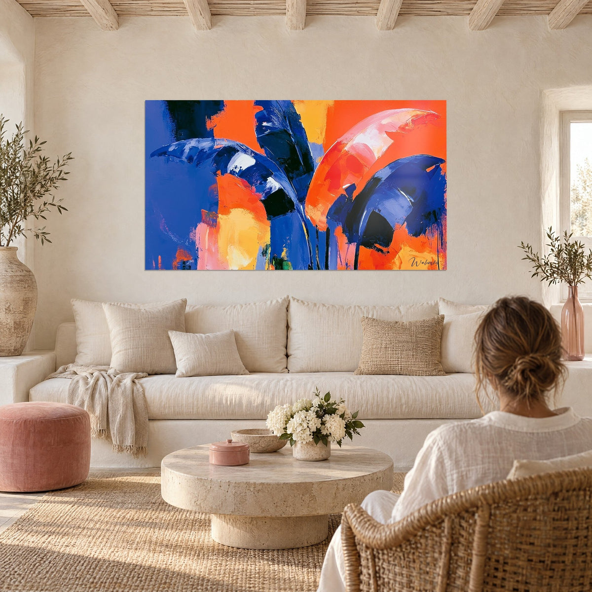Wall art banana leaves in navy blue and bright orange, bold palette-knife strokes, above a sofa in a bright living room