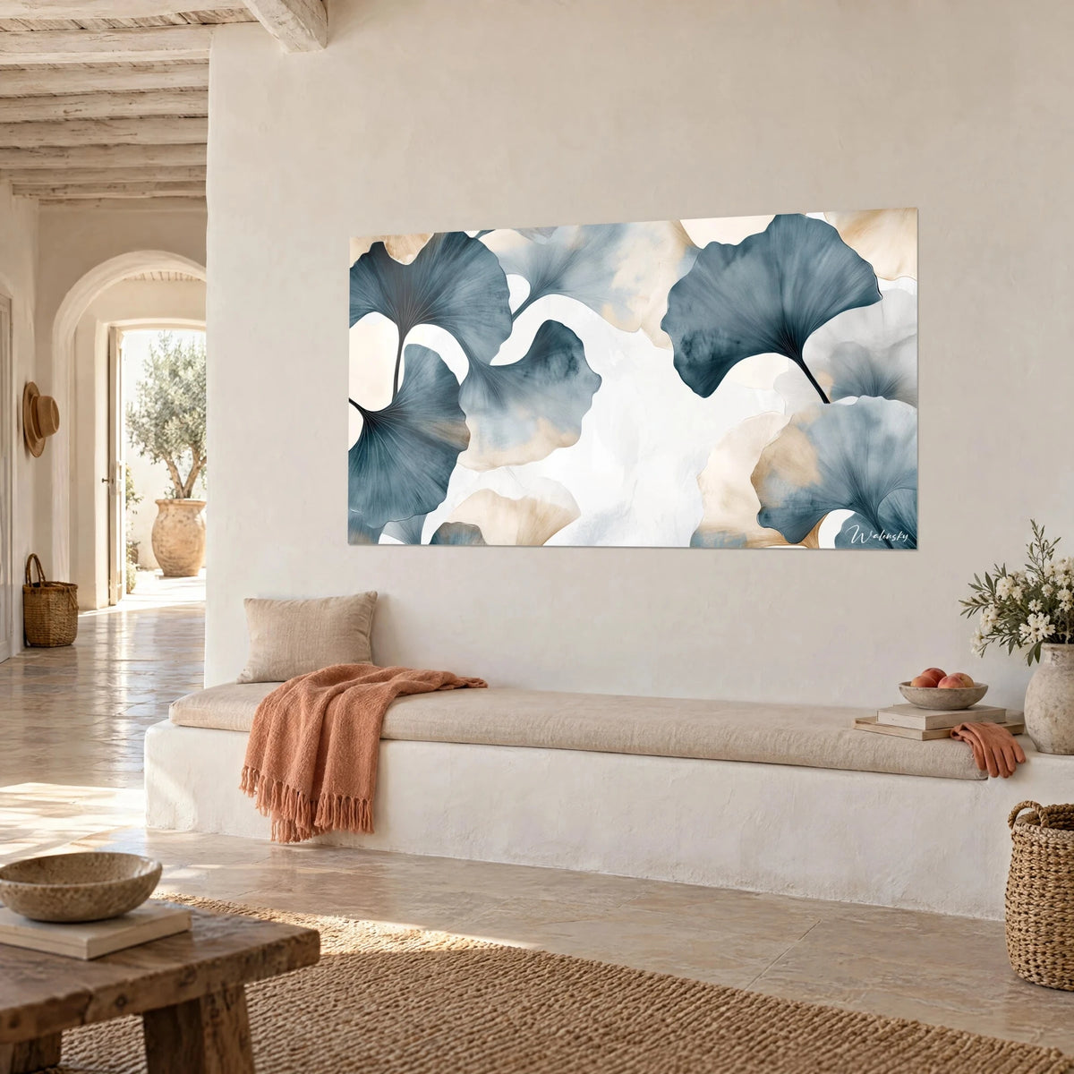 Wall art of slate and cream ginkgo fans on a veiled white background, three-quarter view of a whitewashed Mediterranean wall