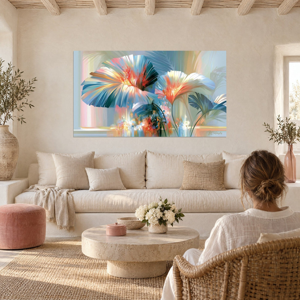 Wall art fan-shaped palm fronds in glacier blue and bright coral, seen from behind by a woman above a sofa in a bright living room
